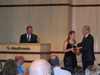 Lindsay Gossack receives her Global Hero award from Dr. Stephen Oesterle, Senior Vice President for Medicine and Technology at Medtronic